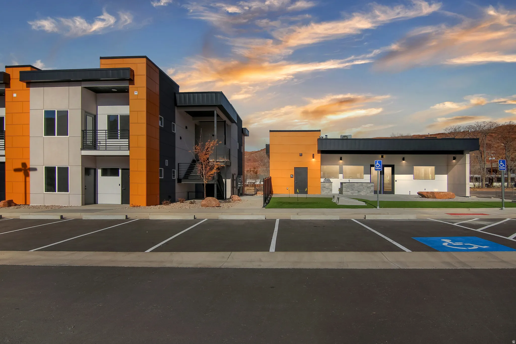 View of building exterior with uncovered parking