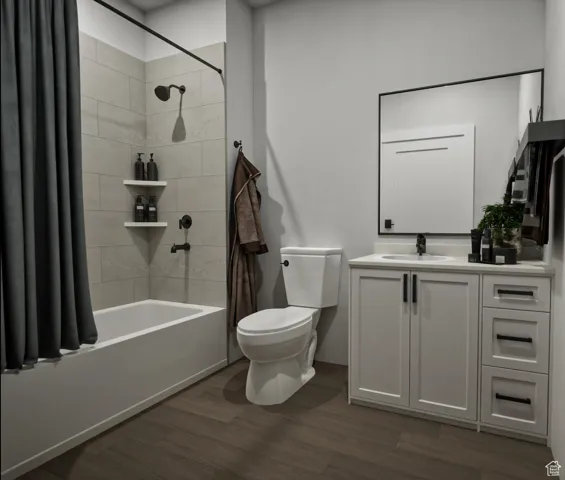 Full bathroom featuring shower / bath combination with curtain, vanity, and dark wood-type flooring