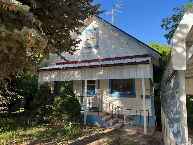 View of front of home featuring a porch and a metal roof