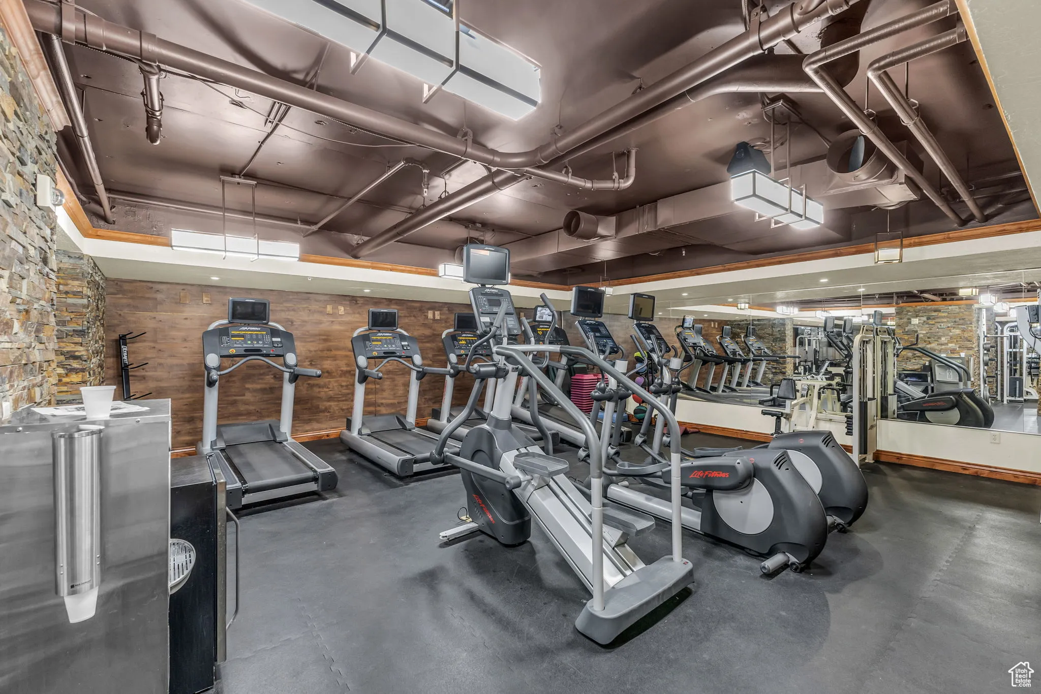 Exercise room featuring wooden walls