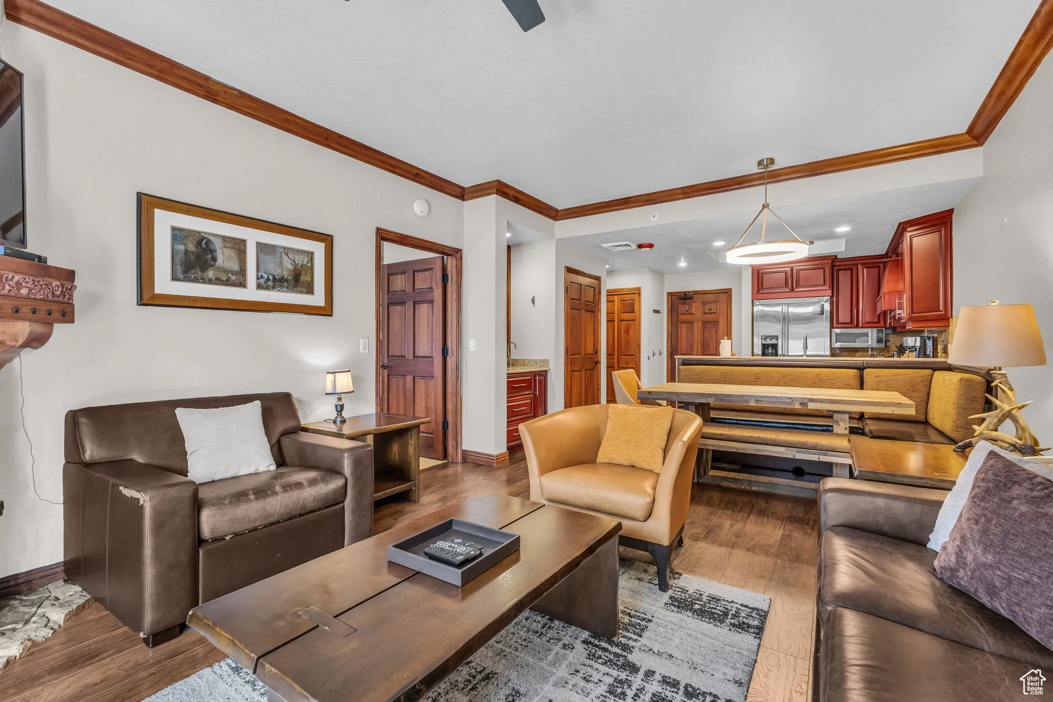 Living area with crown molding, wood finished floors, and recessed lighting