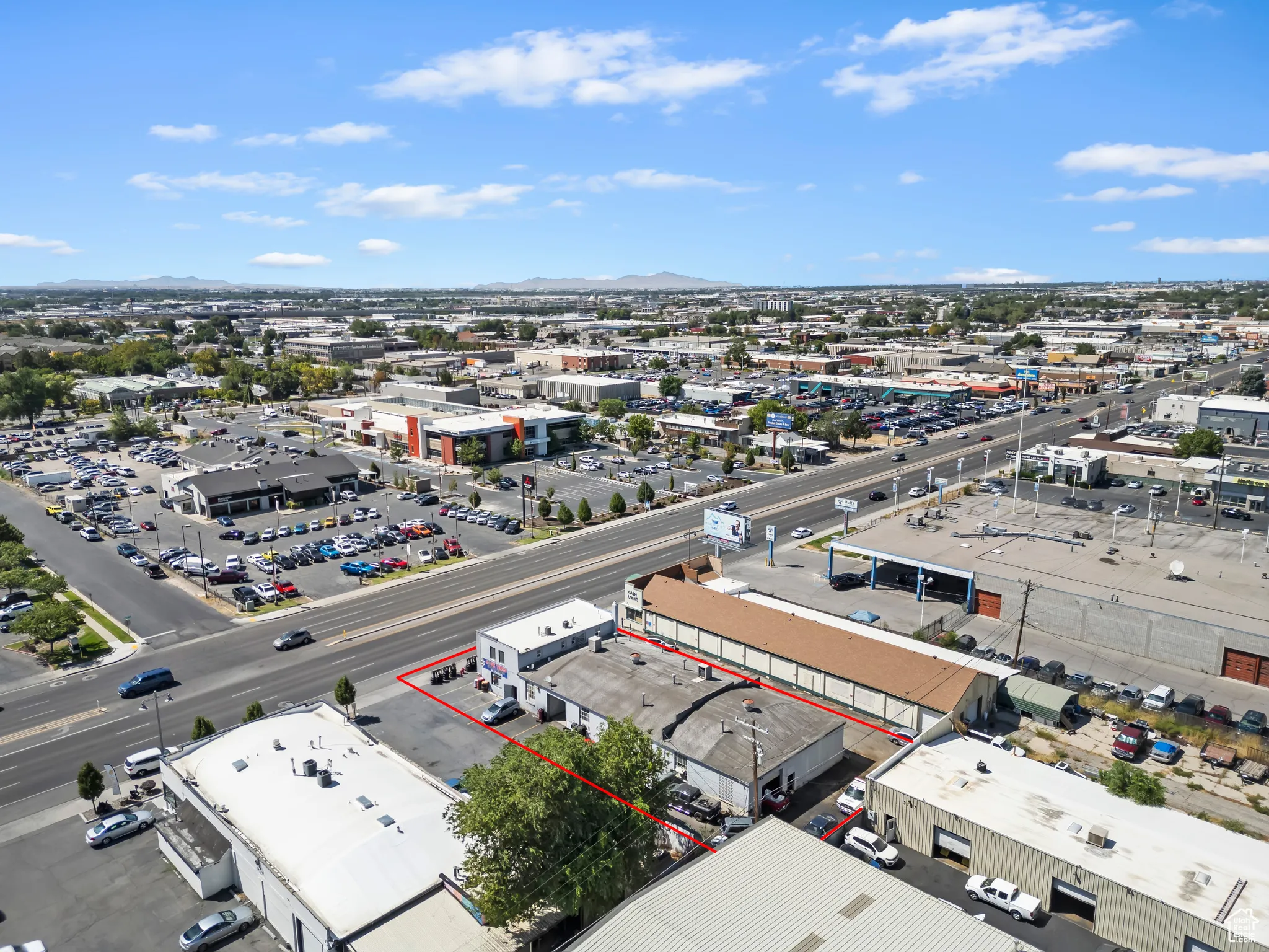 Aerial overview of property's location featuring a mountain backdrop and property boundaries highlighted