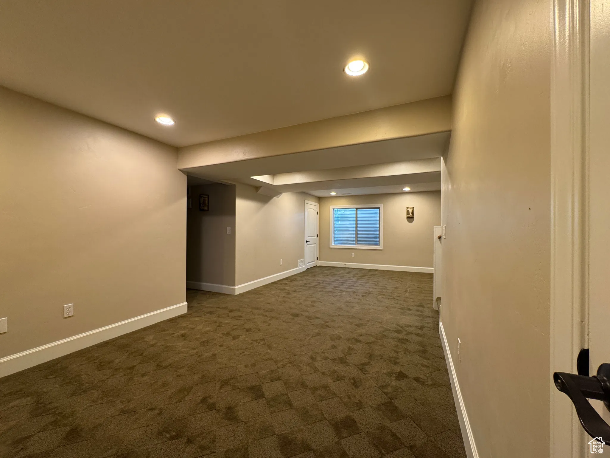 Spare room with dark carpet and recessed lighting