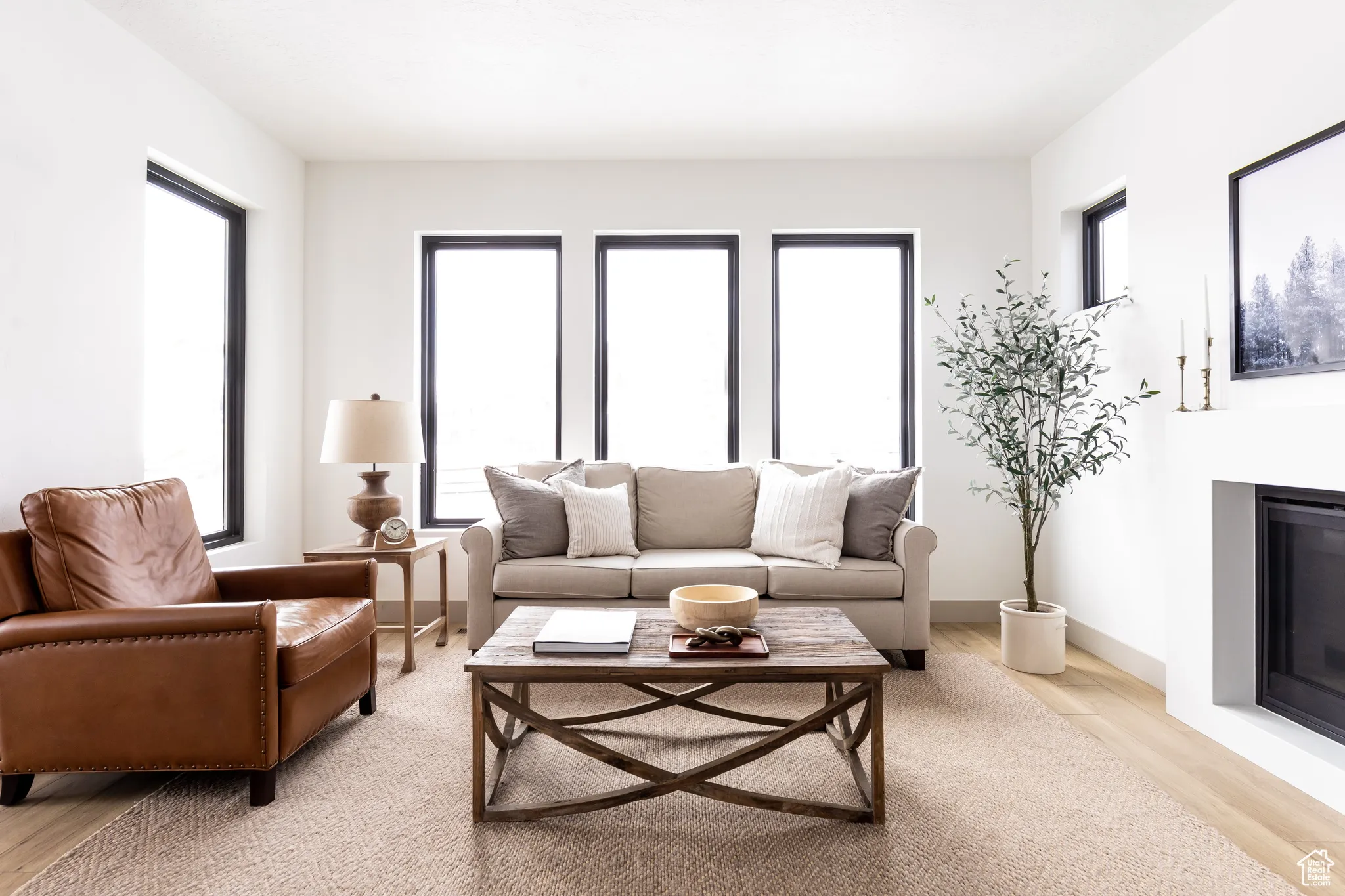 Living room featuring light wood finished floors and a glass covered fireplace
