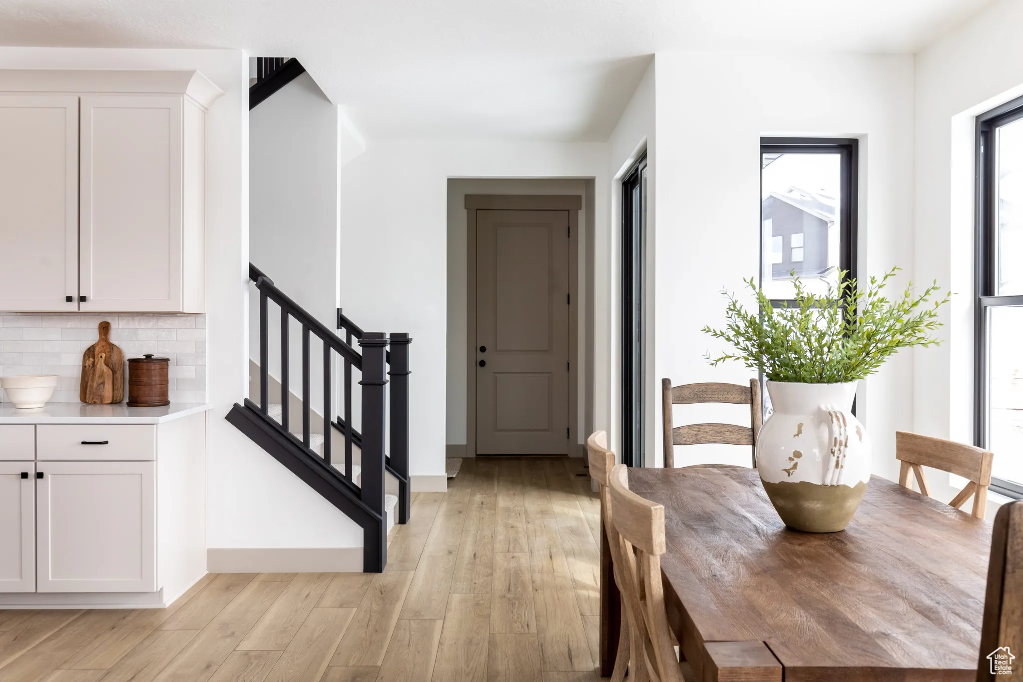 Dining room featuring light wood-type flooring and stairway