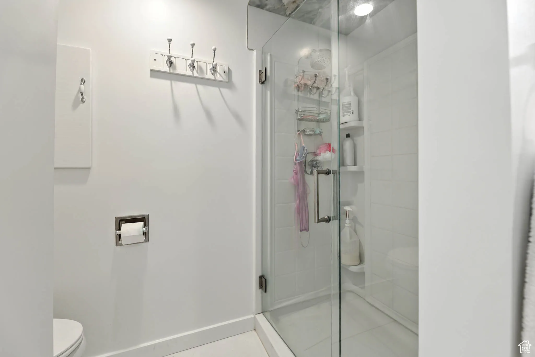 Bathroom with a stall shower and tile patterned floors