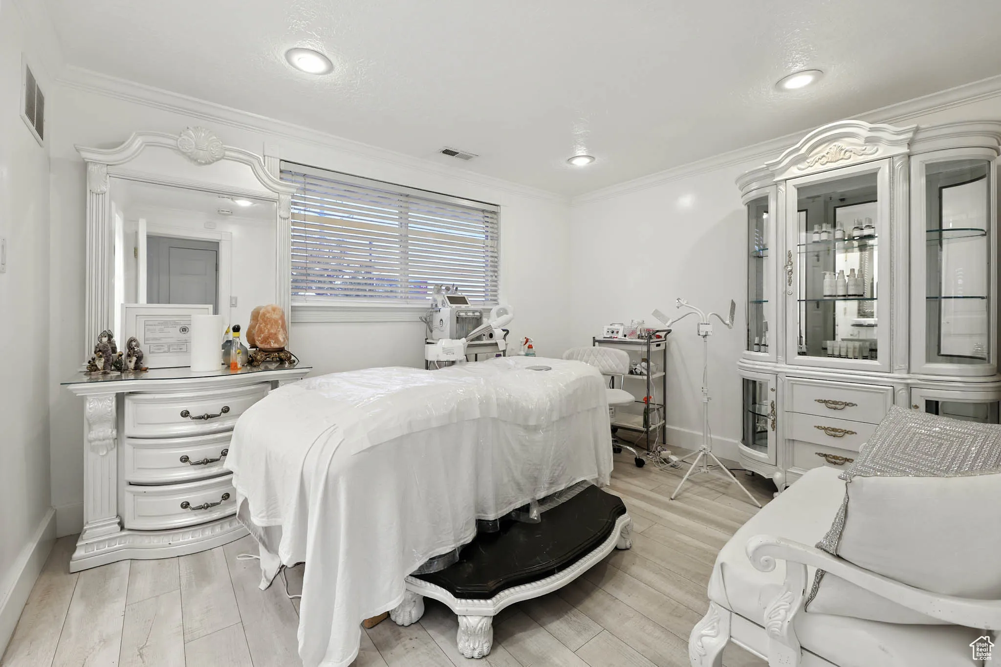 Bedroom featuring ornamental molding, light wood finished floors, and recessed lighting