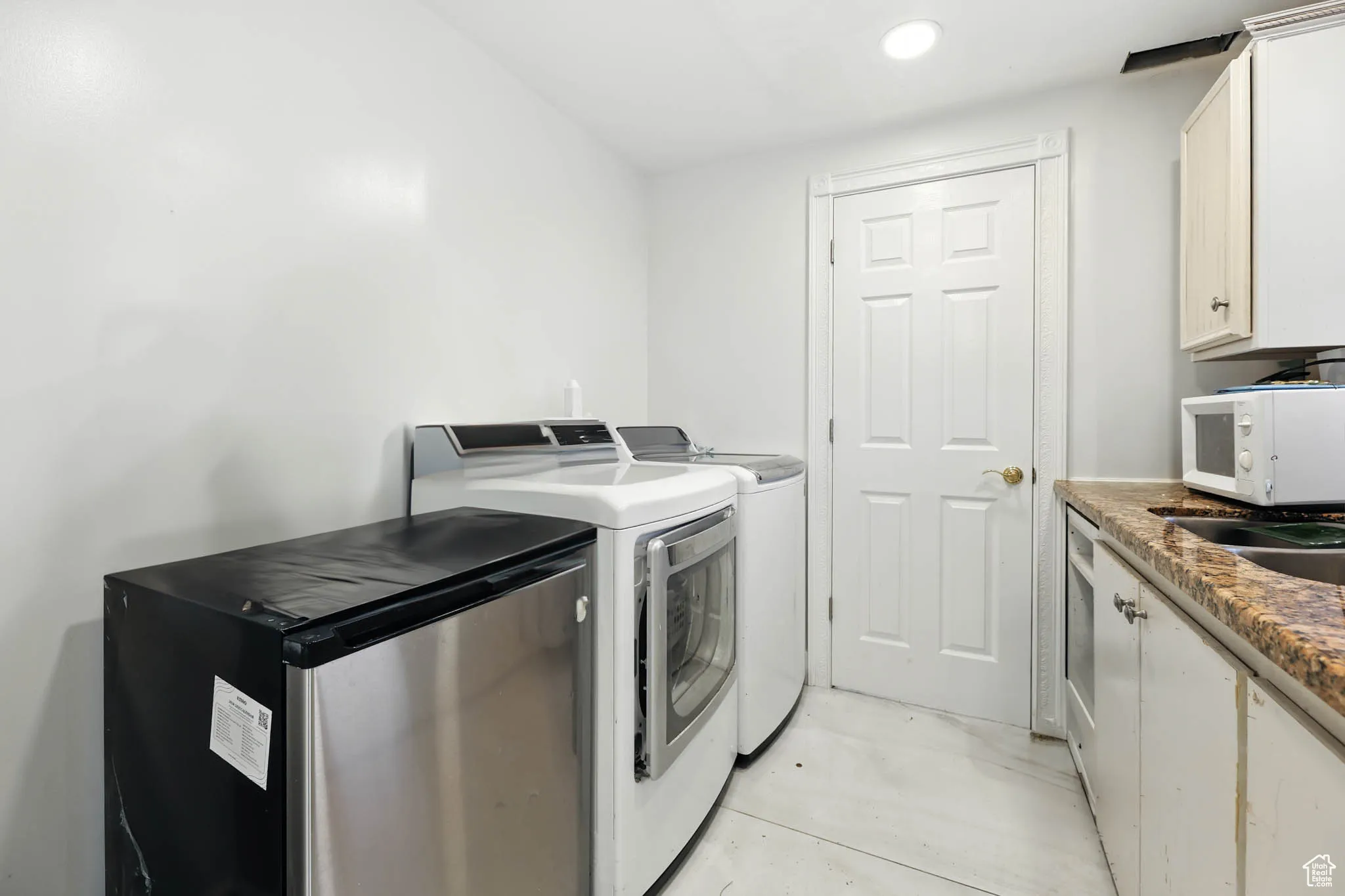 Laundry room with washer and dryer and recessed lighting