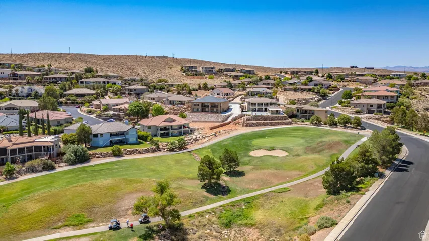 Aerial perspective of suburban area with a local golf course and a mountain backdrop
