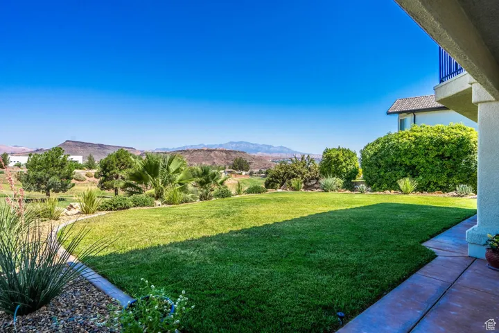 View of green lawn featuring a mountain view