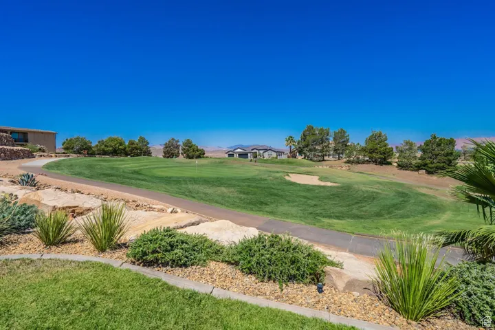 View of community featuring golf course view and a lawn