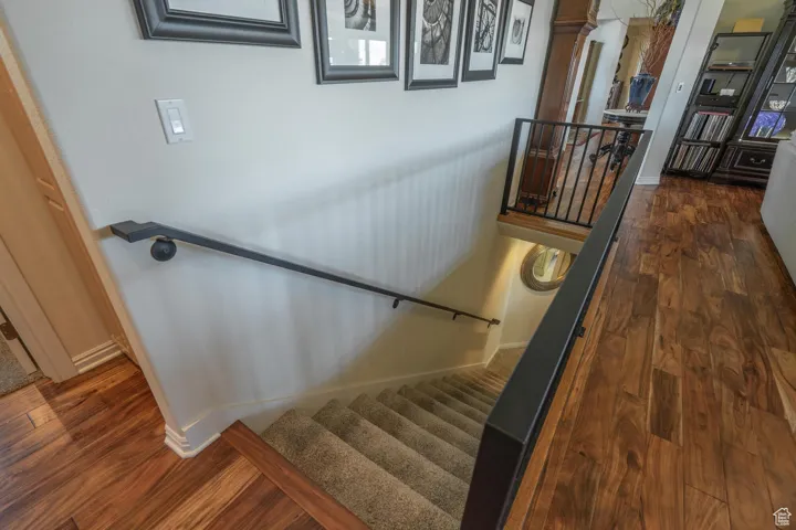 Stairs featuring wood finished floors and baseboards