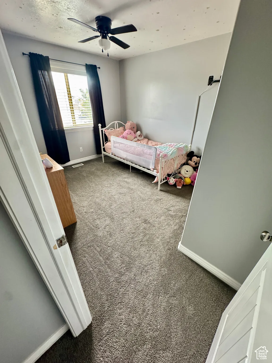 Bedroom with carpet flooring and a ceiling fan