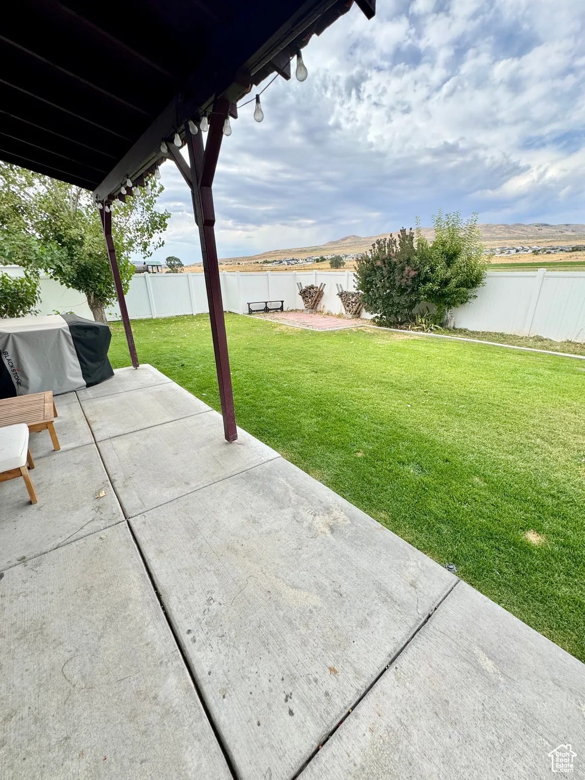Fenced backyard with a patio