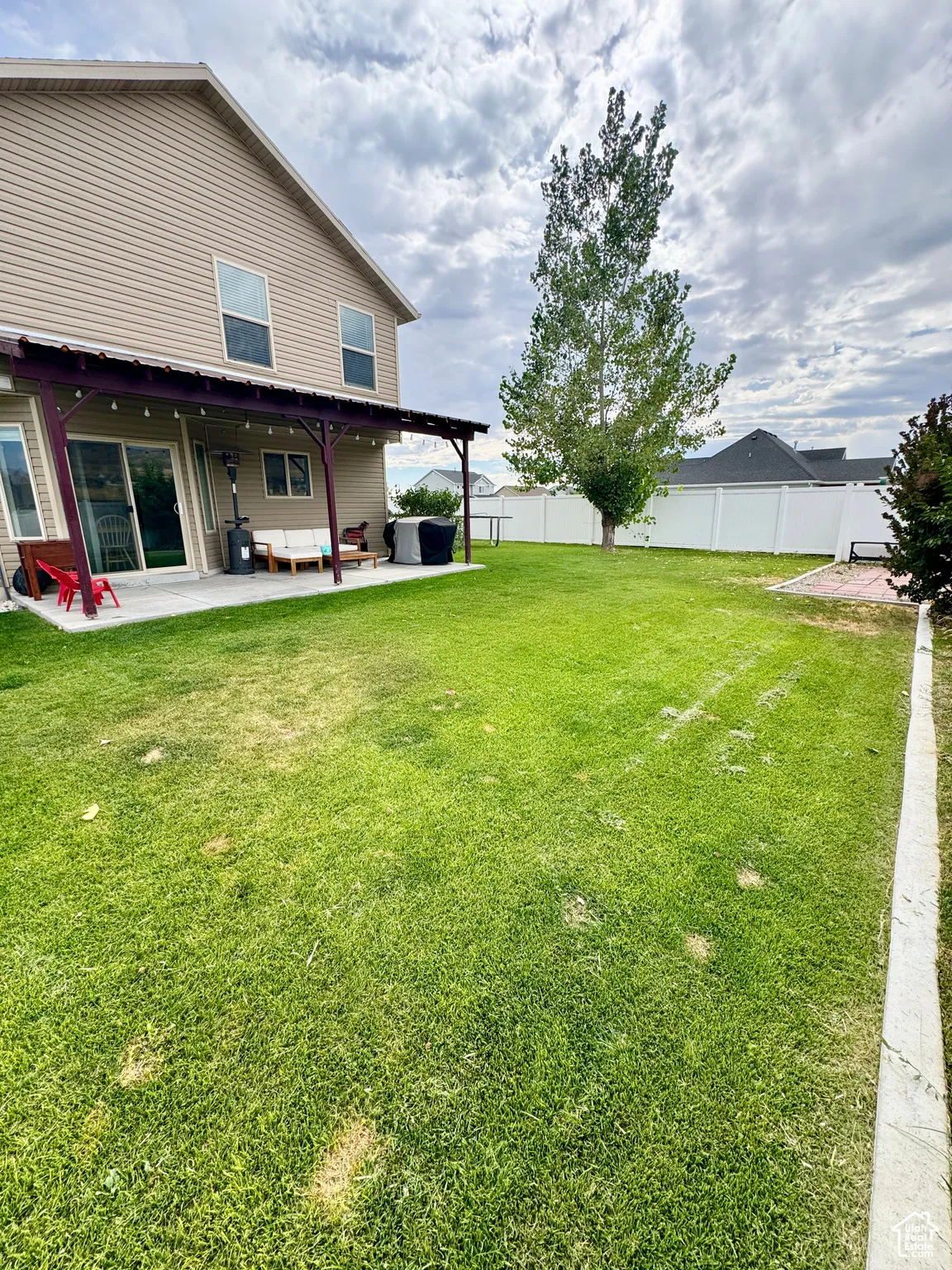 Fenced backyard with a patio area