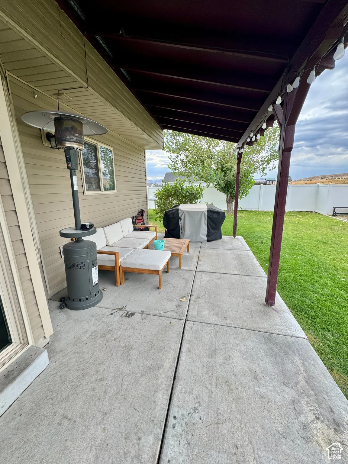 Fenced backyard with a patio area, area for grilling, and an outdoor hangout area