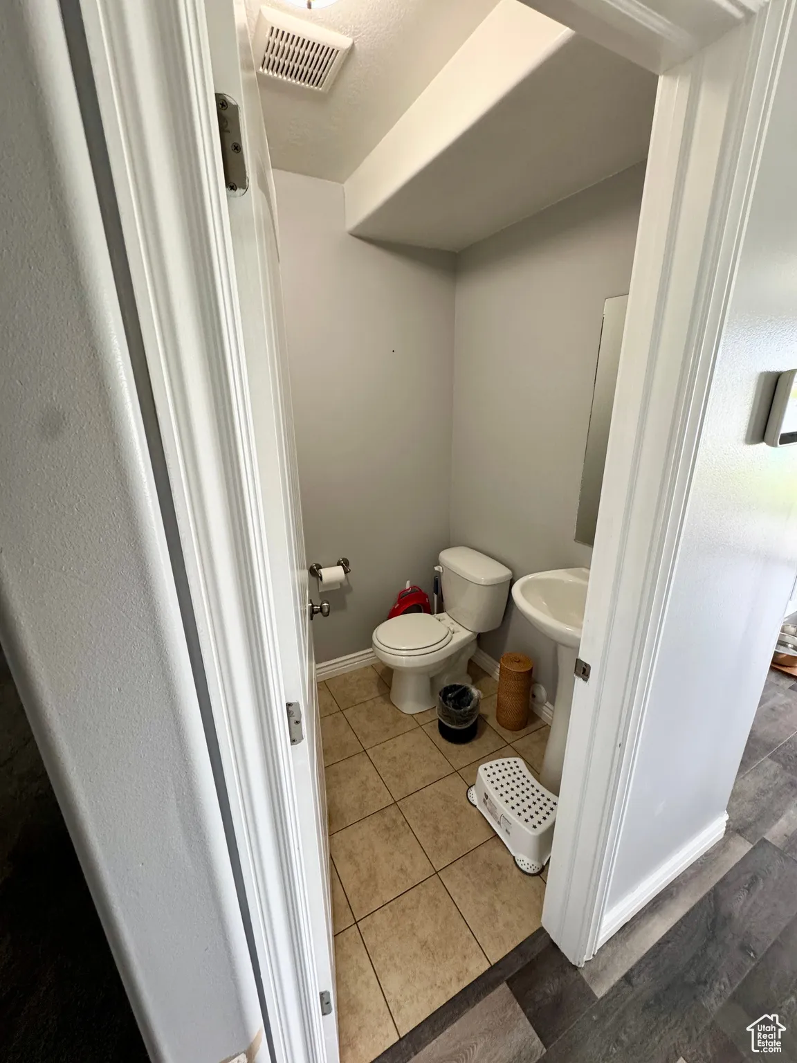 Bathroom featuring light tile patterned floors and a textured ceiling