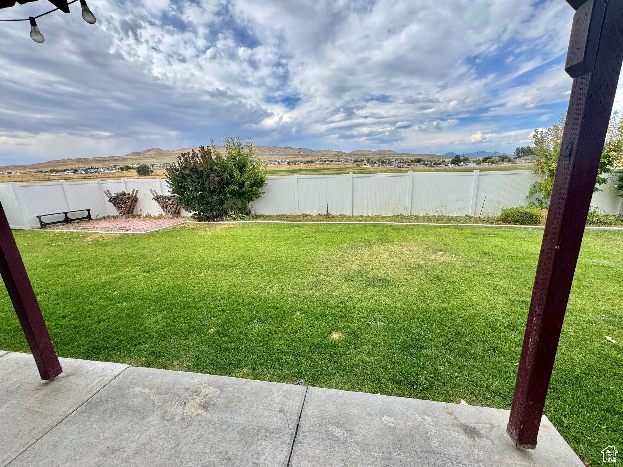 Fenced backyard featuring a patio area and a mountain view