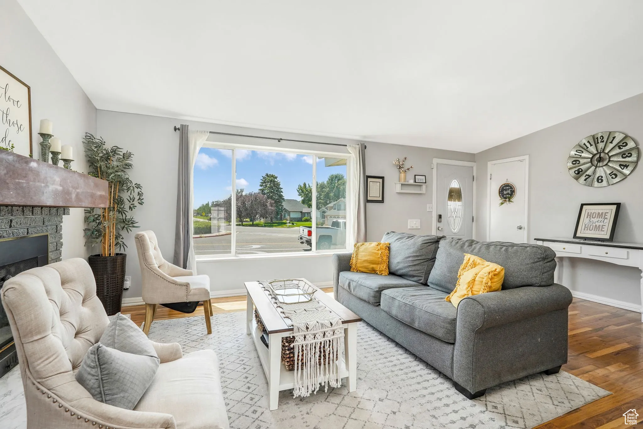 Living area with wood finished floors and a brick fireplace