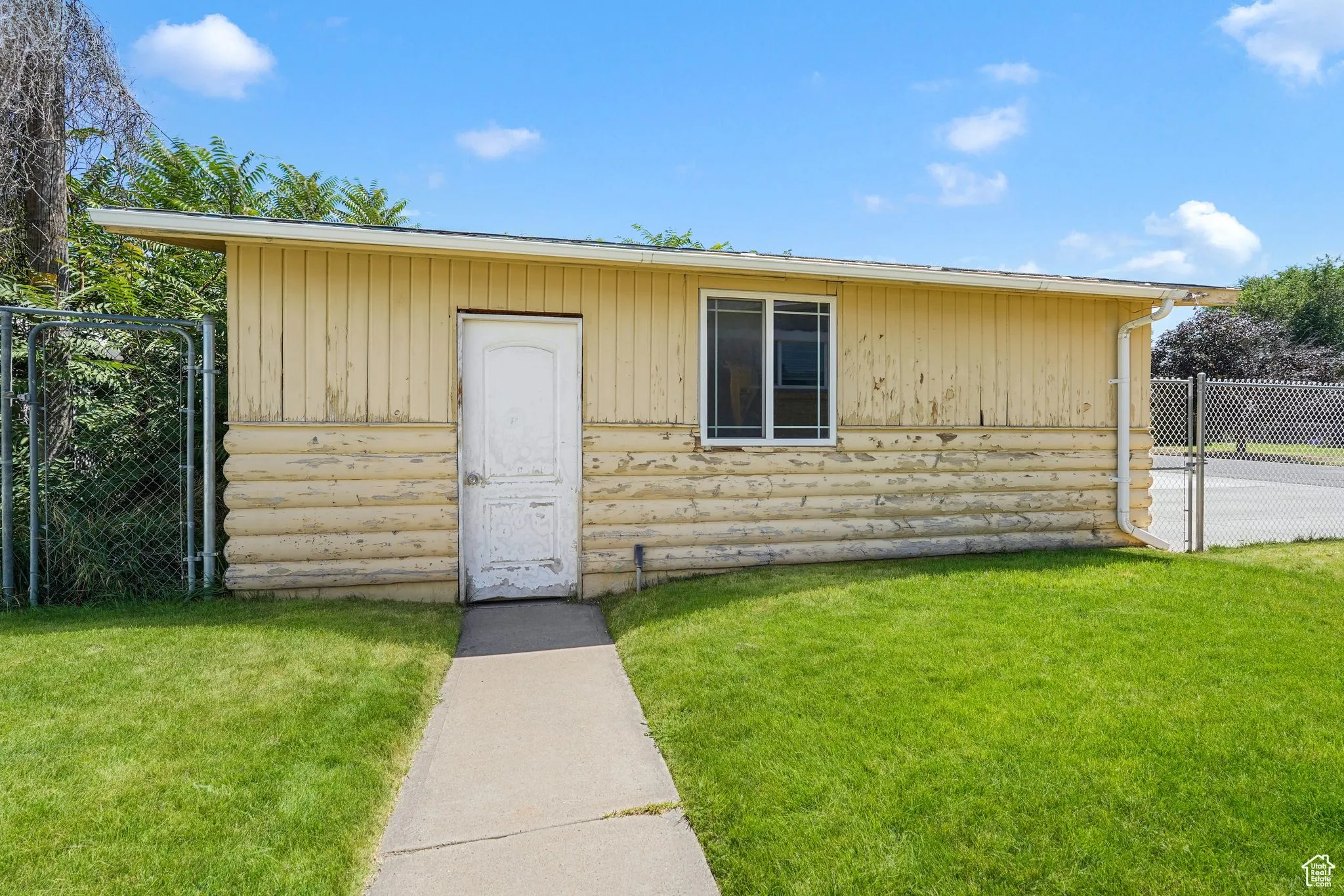 View of outbuilding featuring a gate