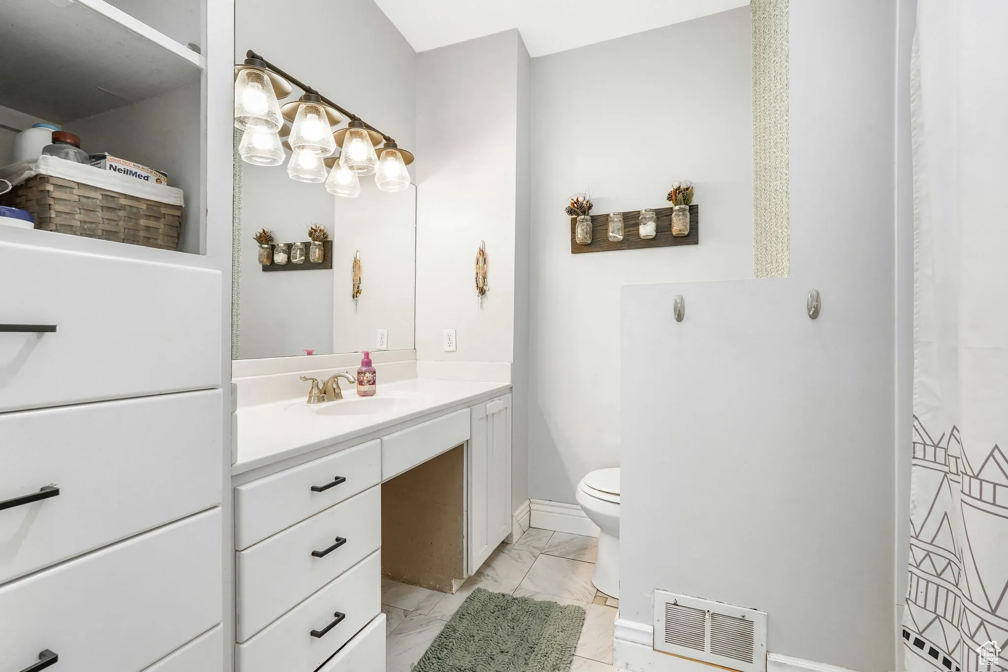 Bathroom with vanity and light marble finish floors