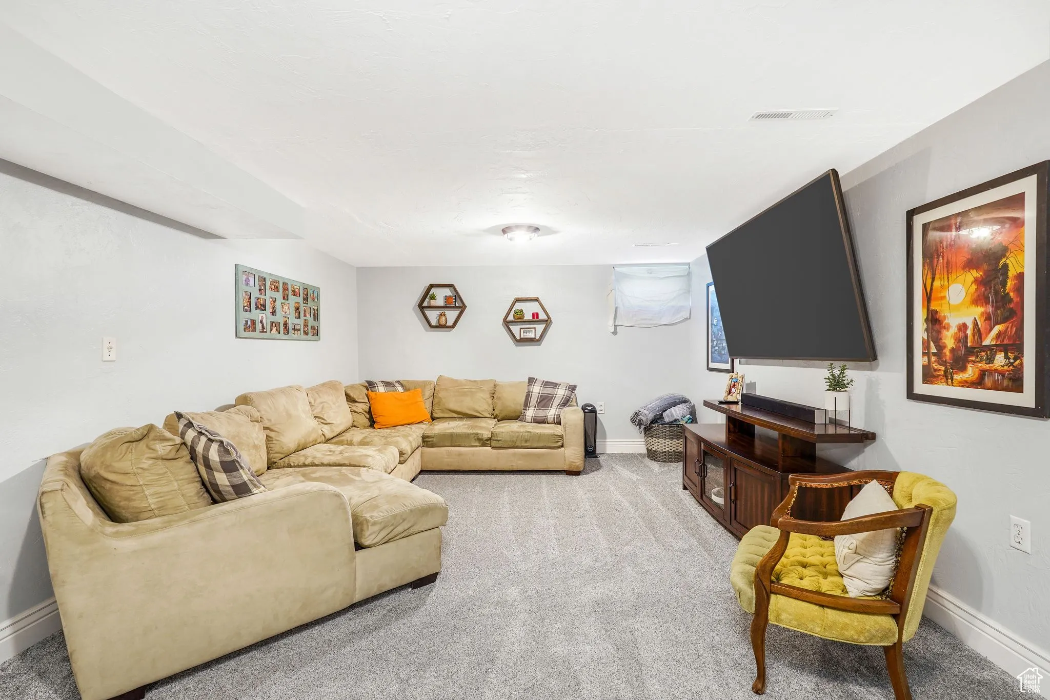 Living area with light carpet and baseboards