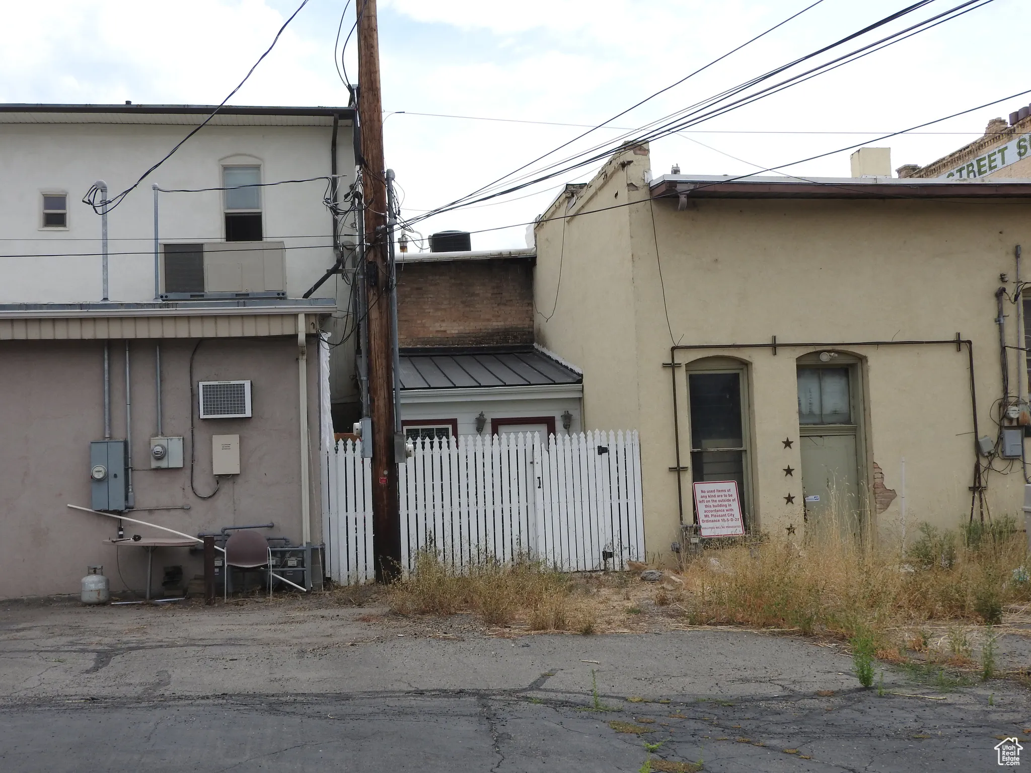 Back of property with stucco siding, a metal roof, and a standing seam roof