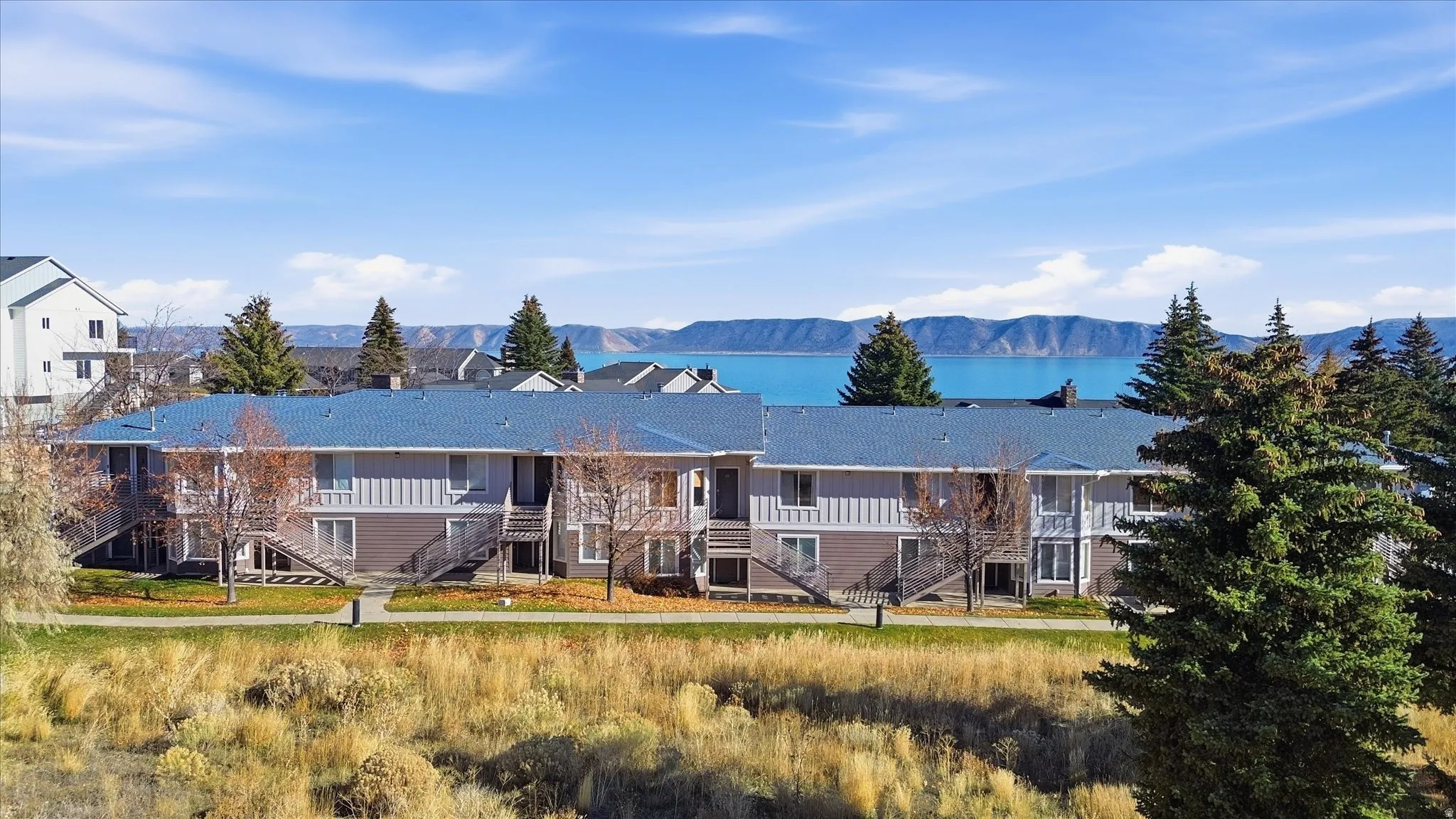 View of front of home featuring stairway, a water and mountain view, and board and batten siding