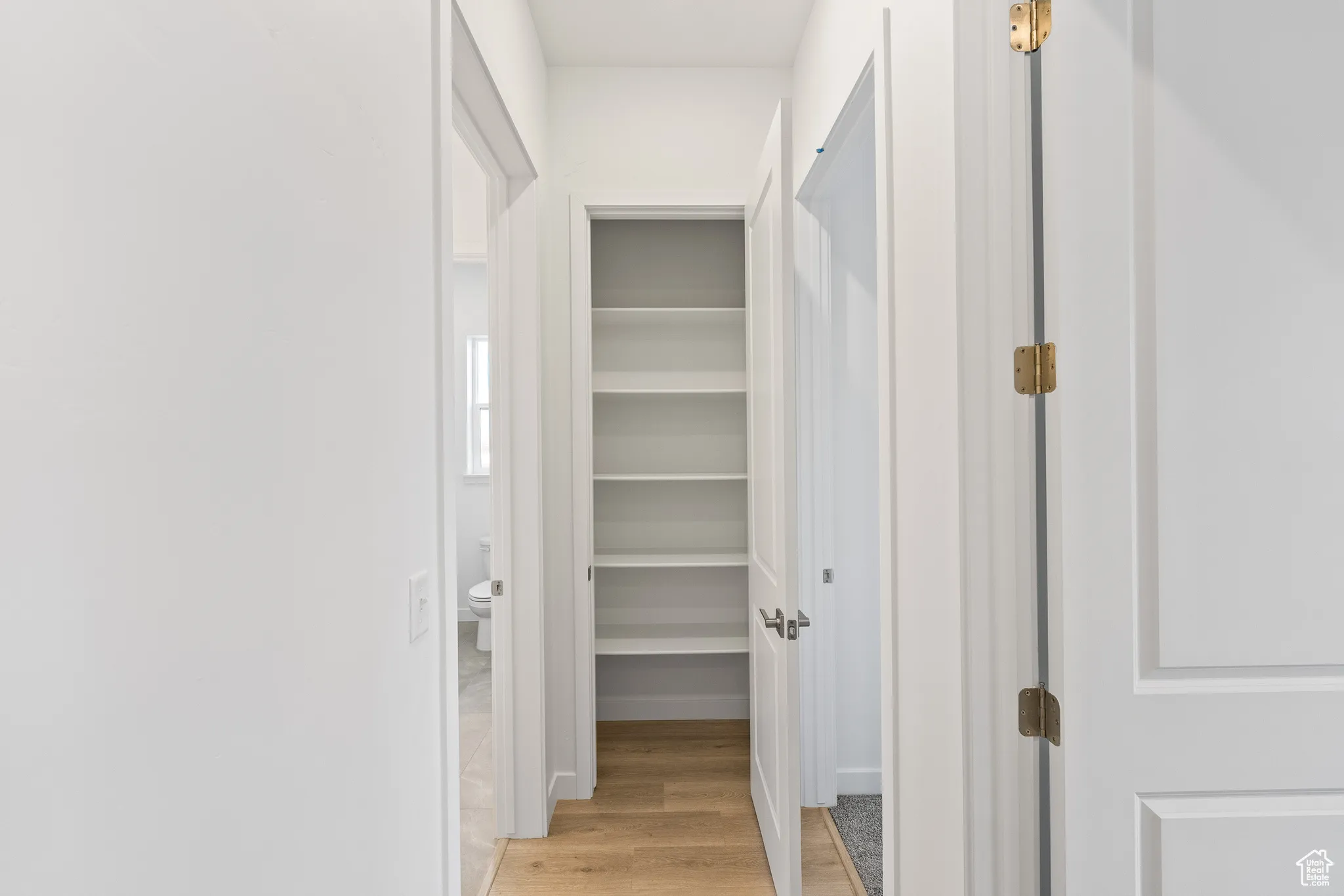 Hallway with light wood-style floors