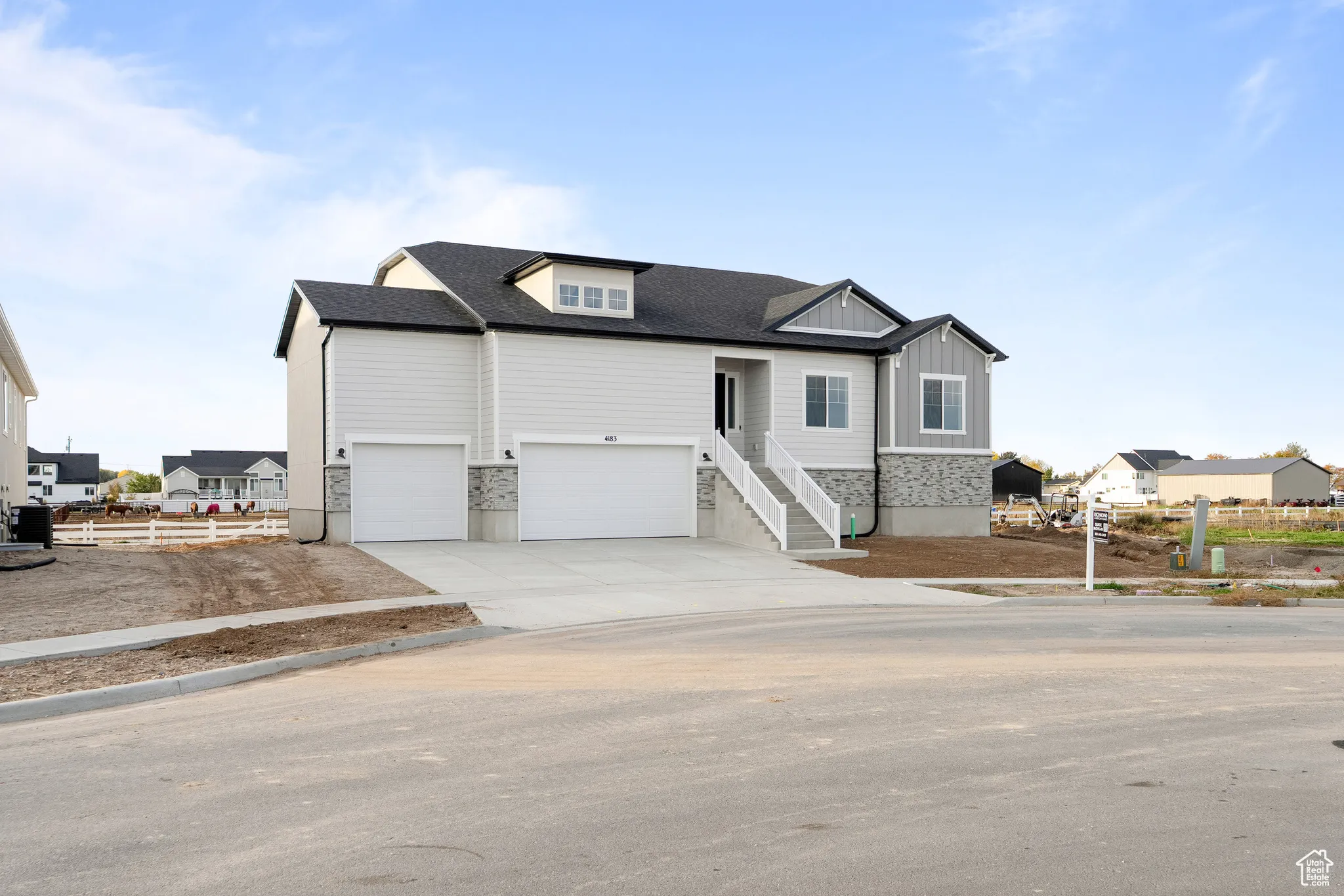 View of front of home featuring concrete driveway, a garage, board and batten siding, and a shingled roof