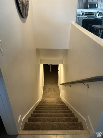 Stairs featuring carpet and baseboards