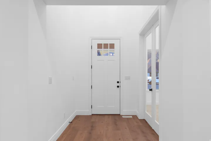 Entryway featuring wood finished floors and baseboards