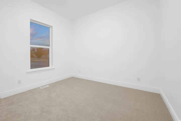 Empty room with carpet floors and baseboards