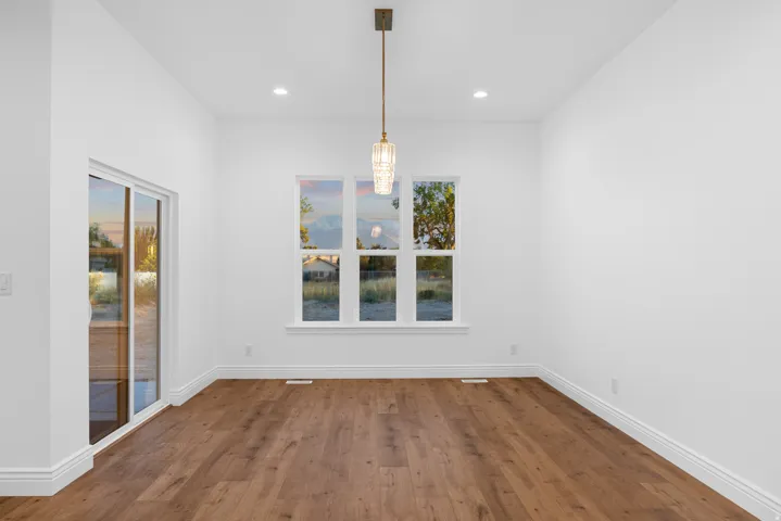 Unfurnished dining area with dark wood finished floors and recessed lighting