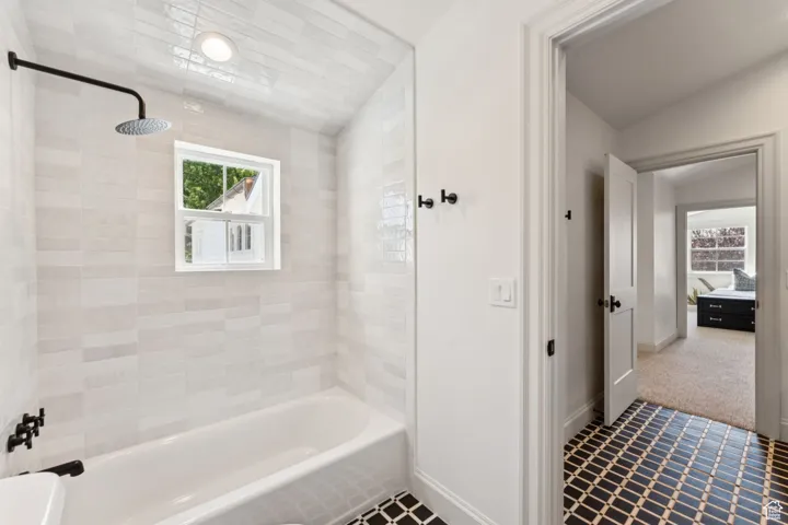 Full bath featuring shower / bathtub combination and tile patterned floors