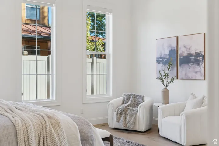 Bedroom with wood finished floors and baseboards