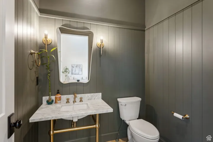 Half bath with a sink and toilet