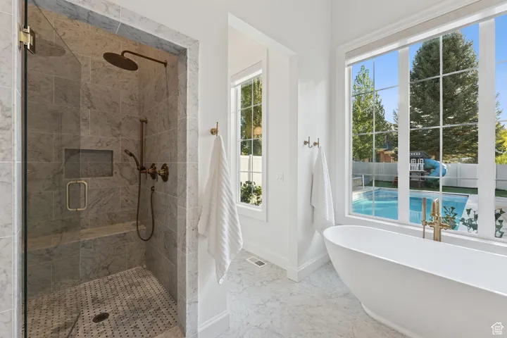 Bathroom with a stall shower and a freestanding tub