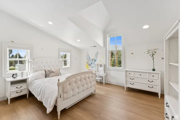 Bedroom featuring lofted ceiling, recessed lighting, and light wood finished floors