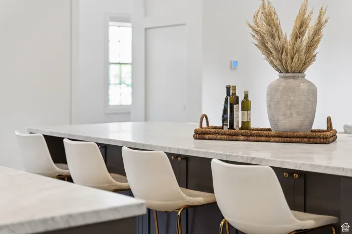 Kitchen with light stone countertops and a kitchen bar