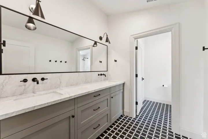 Bathroom featuring double vanity and a shower