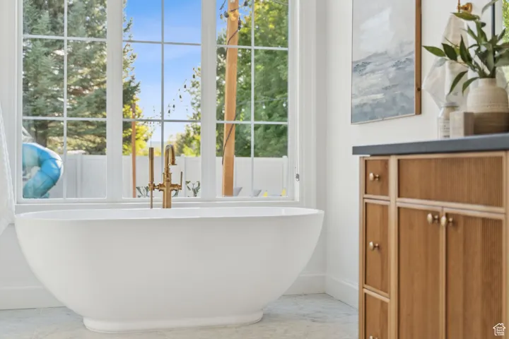 Bathroom featuring baseboards and a soaking tub