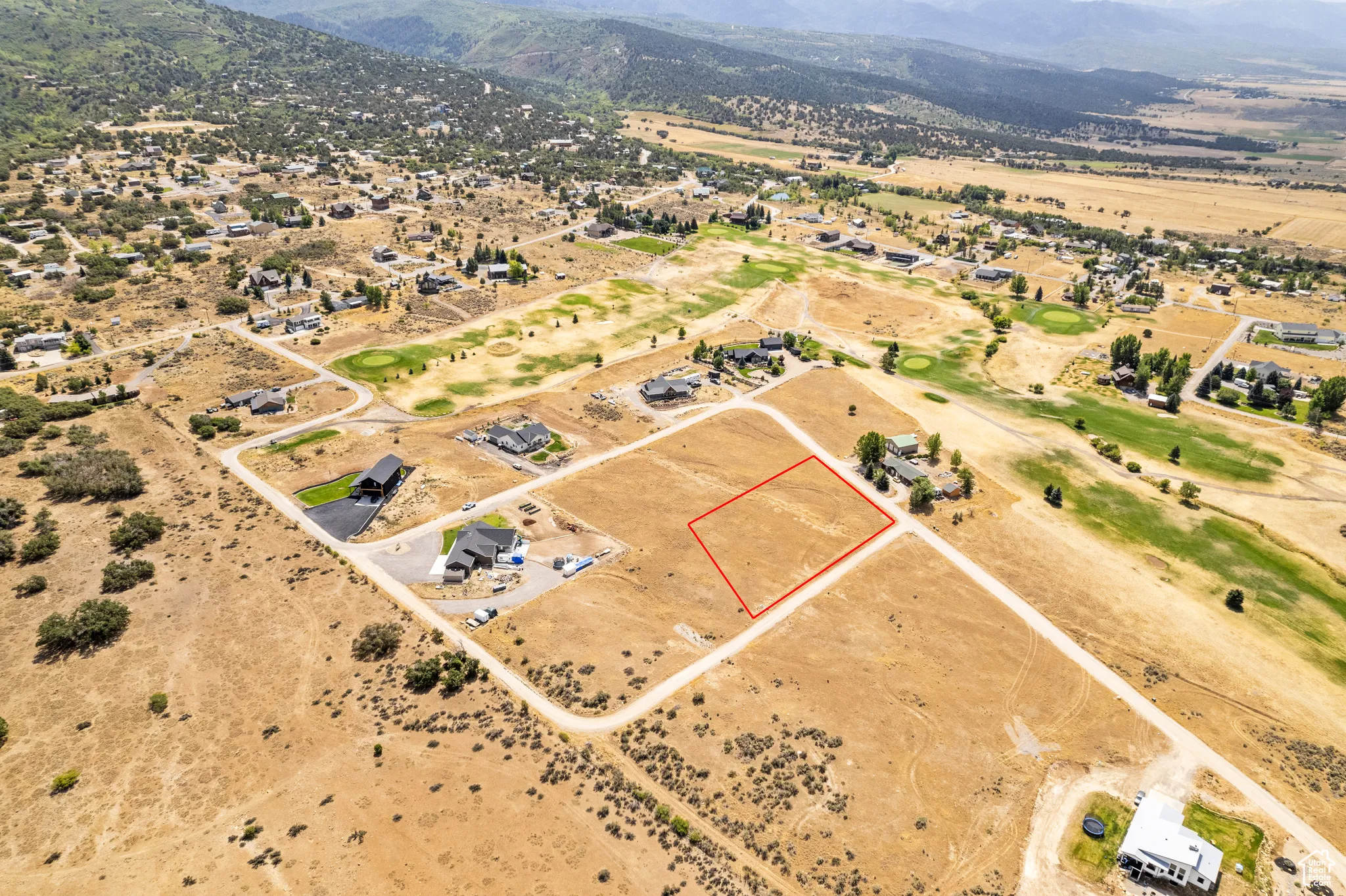Overview of rural landscape with a mountain backdrop and property boundaries highlighted
