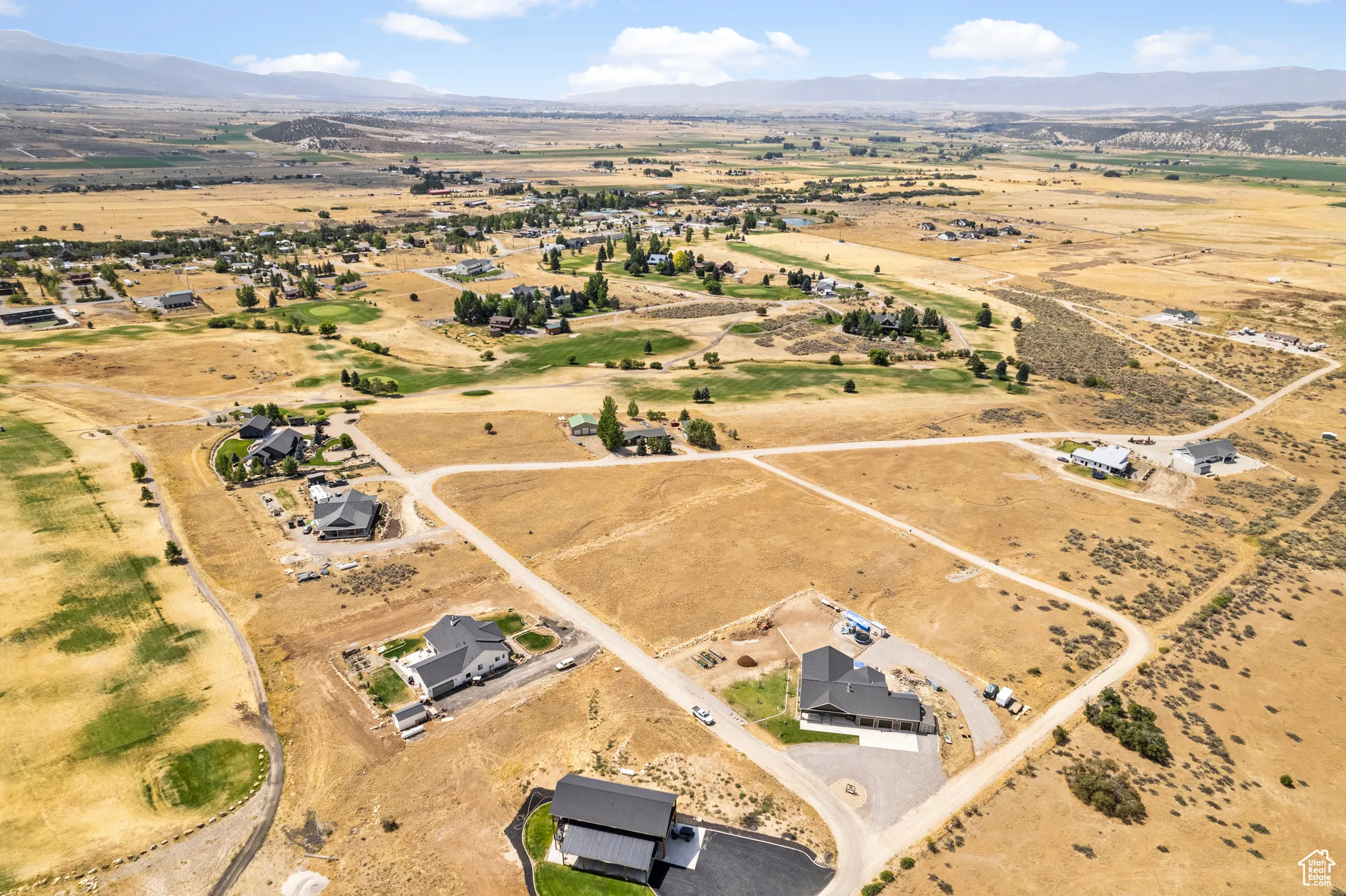 Aerial view of property's location with a mountain backdrop and rural landscape