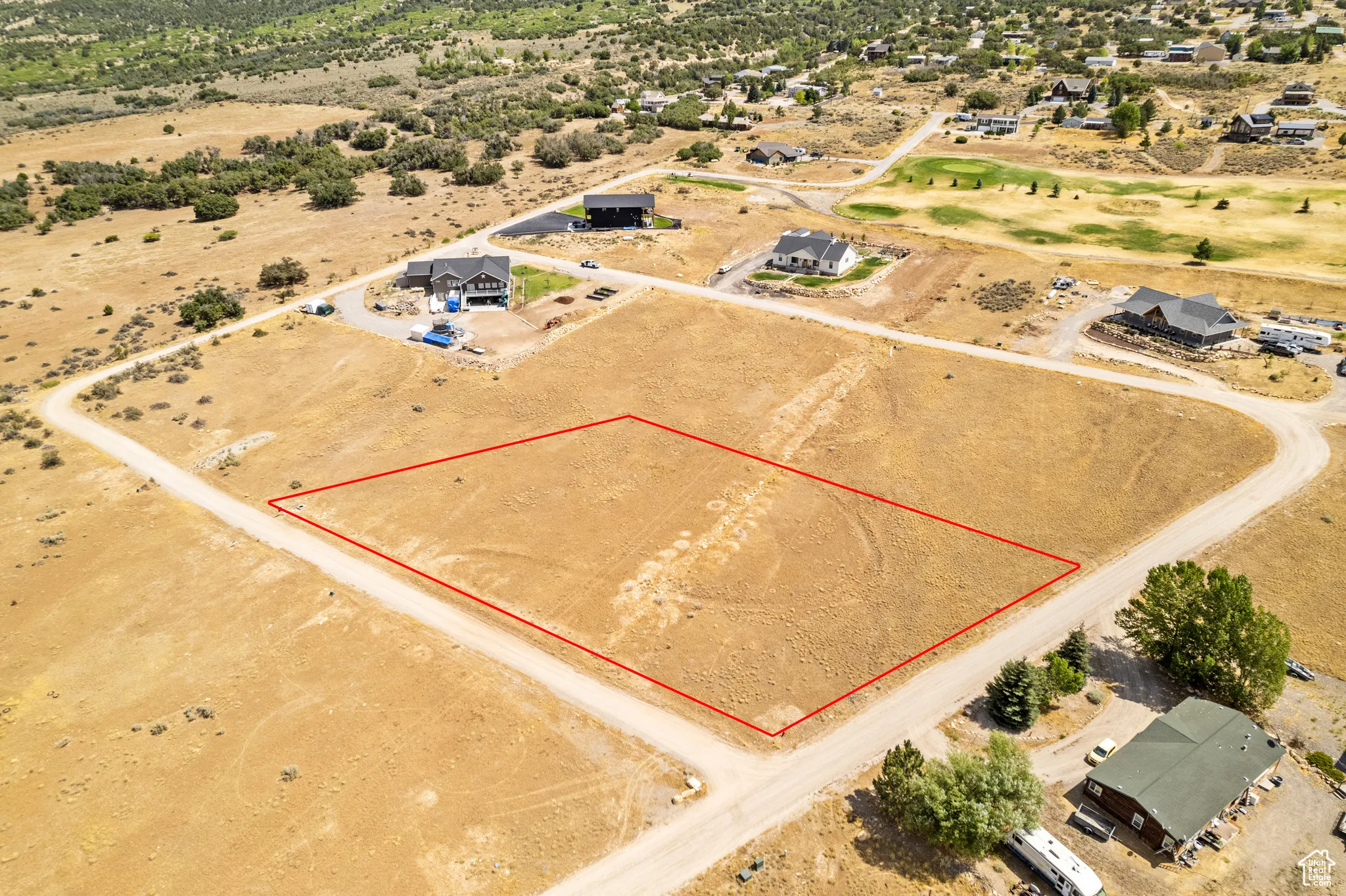 Aerial view of sparsely populated area featuring property parcel outlined and a desert landscape
