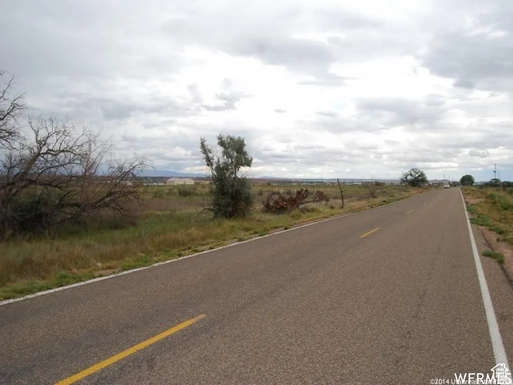 View of asphalt street featuring a view of rural / pastoral area