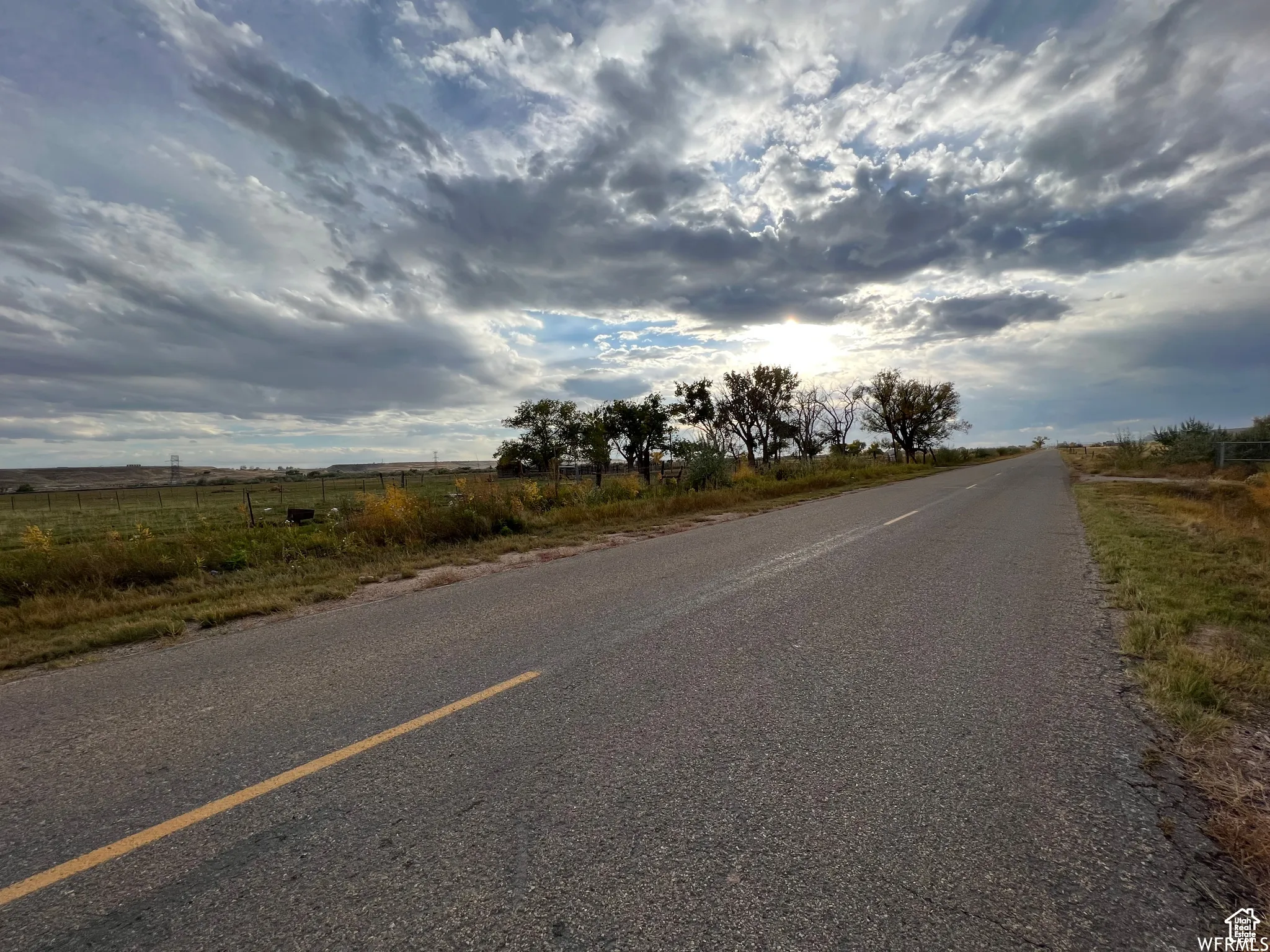 View of asphalt road with a rural view