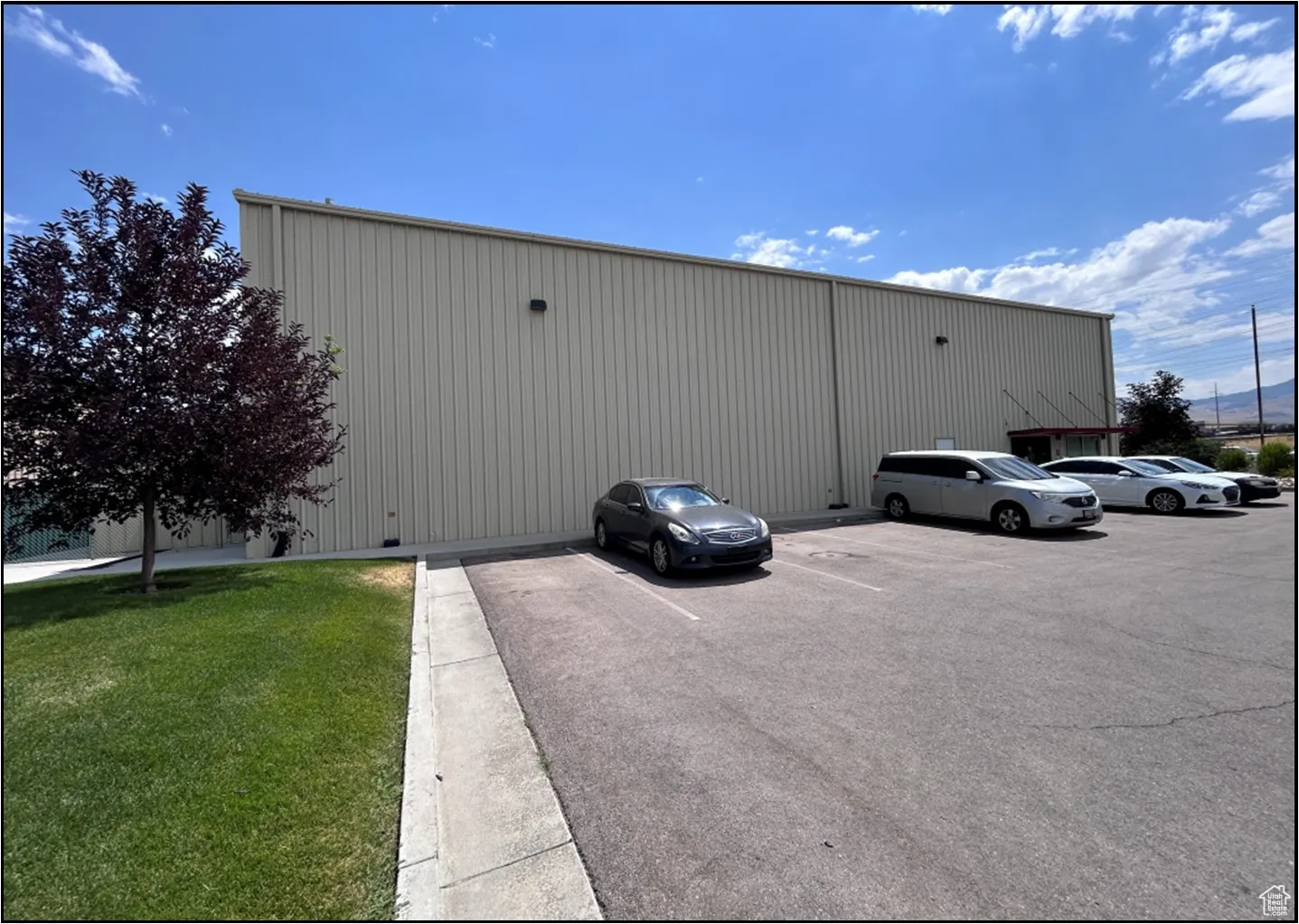 View of building exterior with uncovered parking