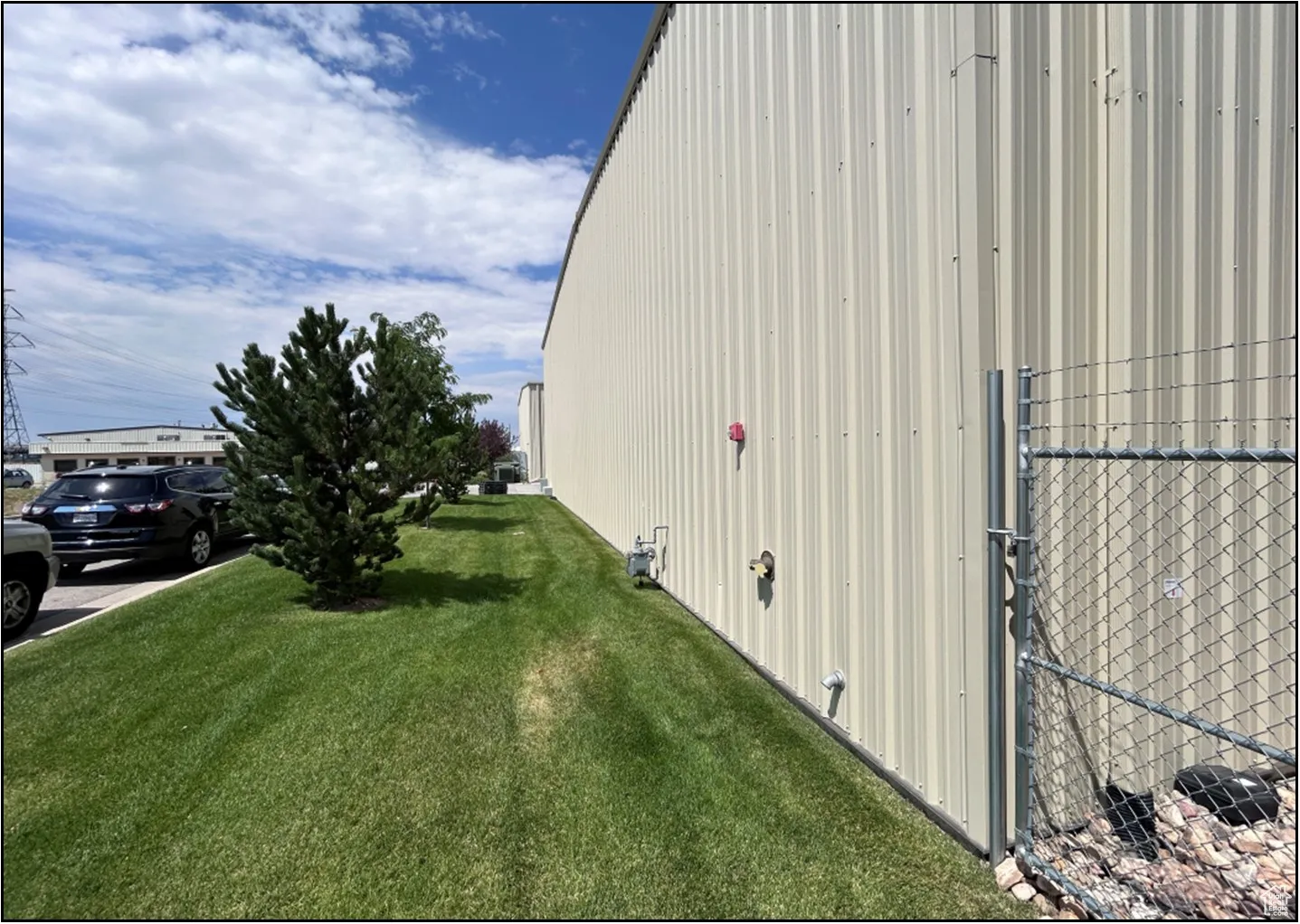 View of side of property with a lawn