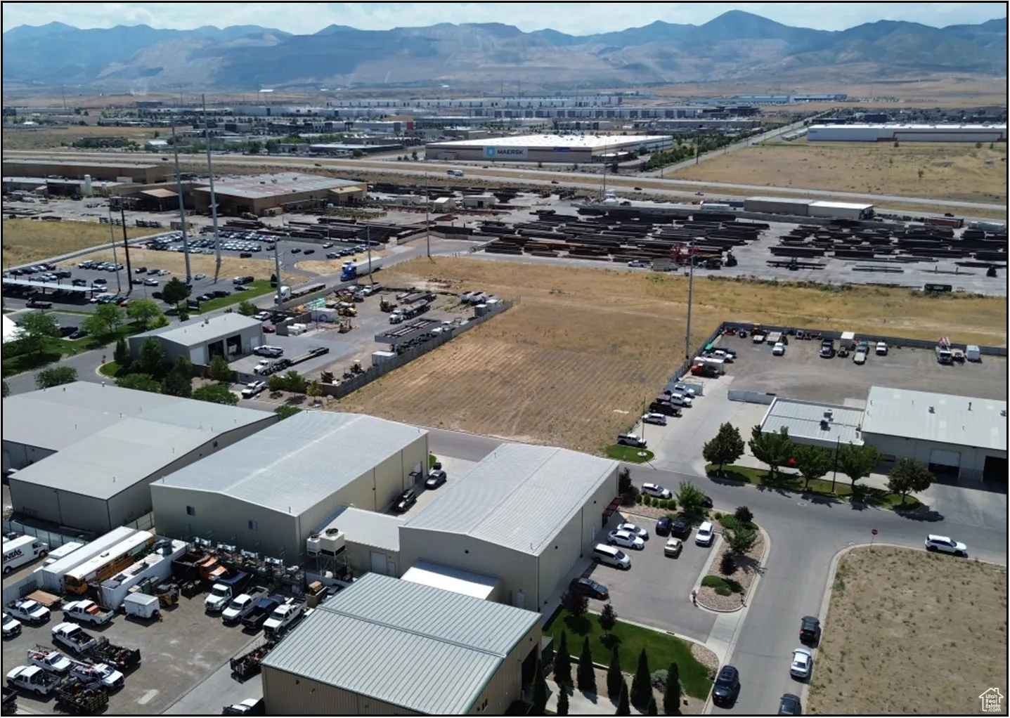 Drone / aerial view of an industrial area and a mountainous background